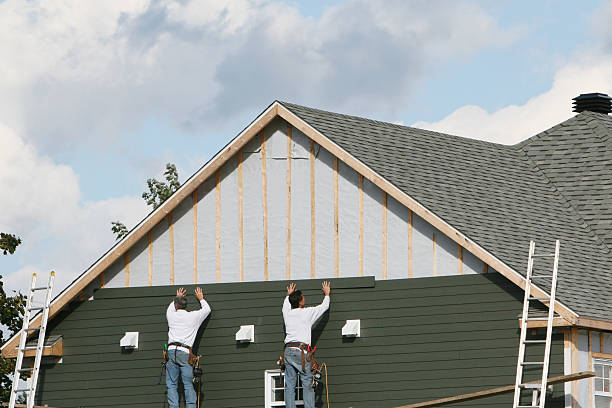 Professional Storm Damage Siding Repair technician working in Lansing, OH